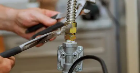 plumber adjusting gas line