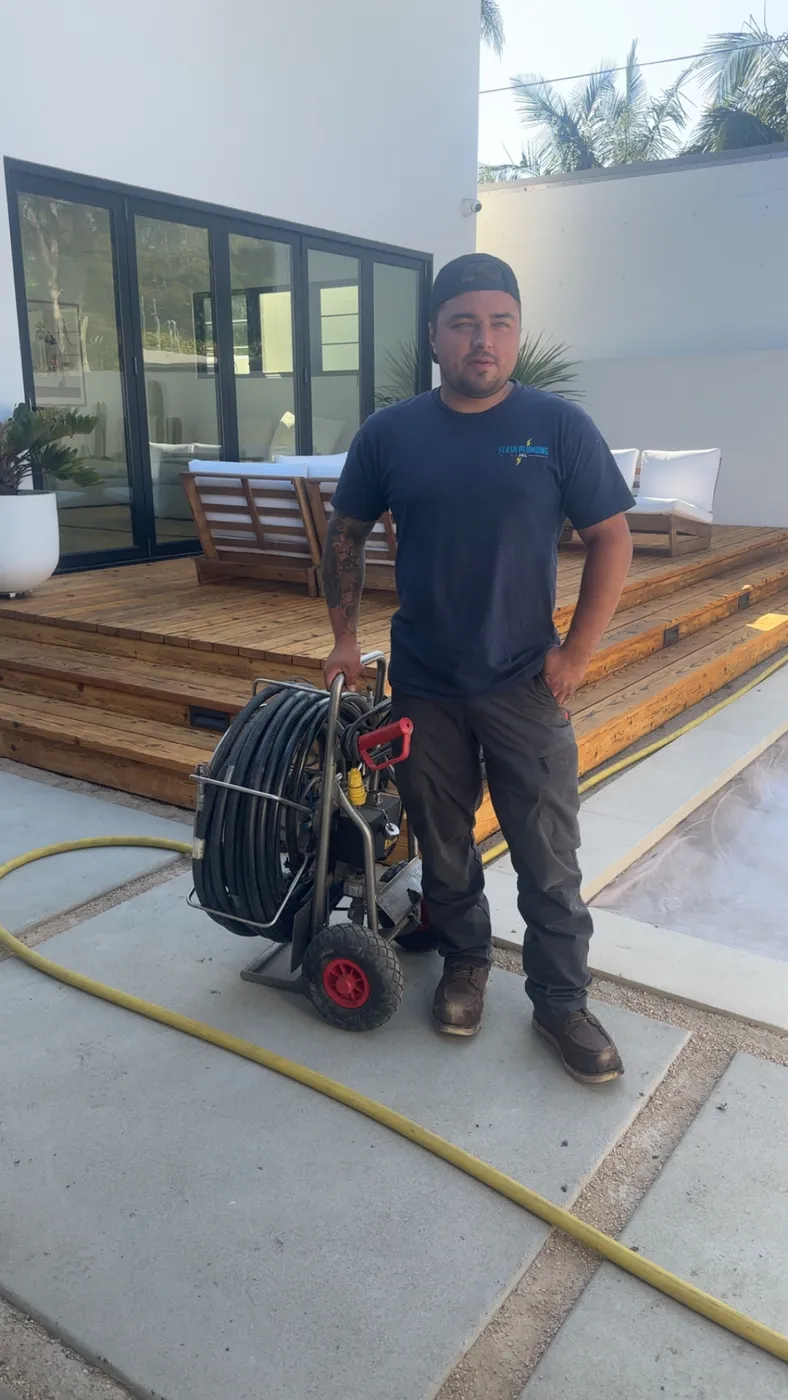 A Flash Plumbing technician on a residential service visit
