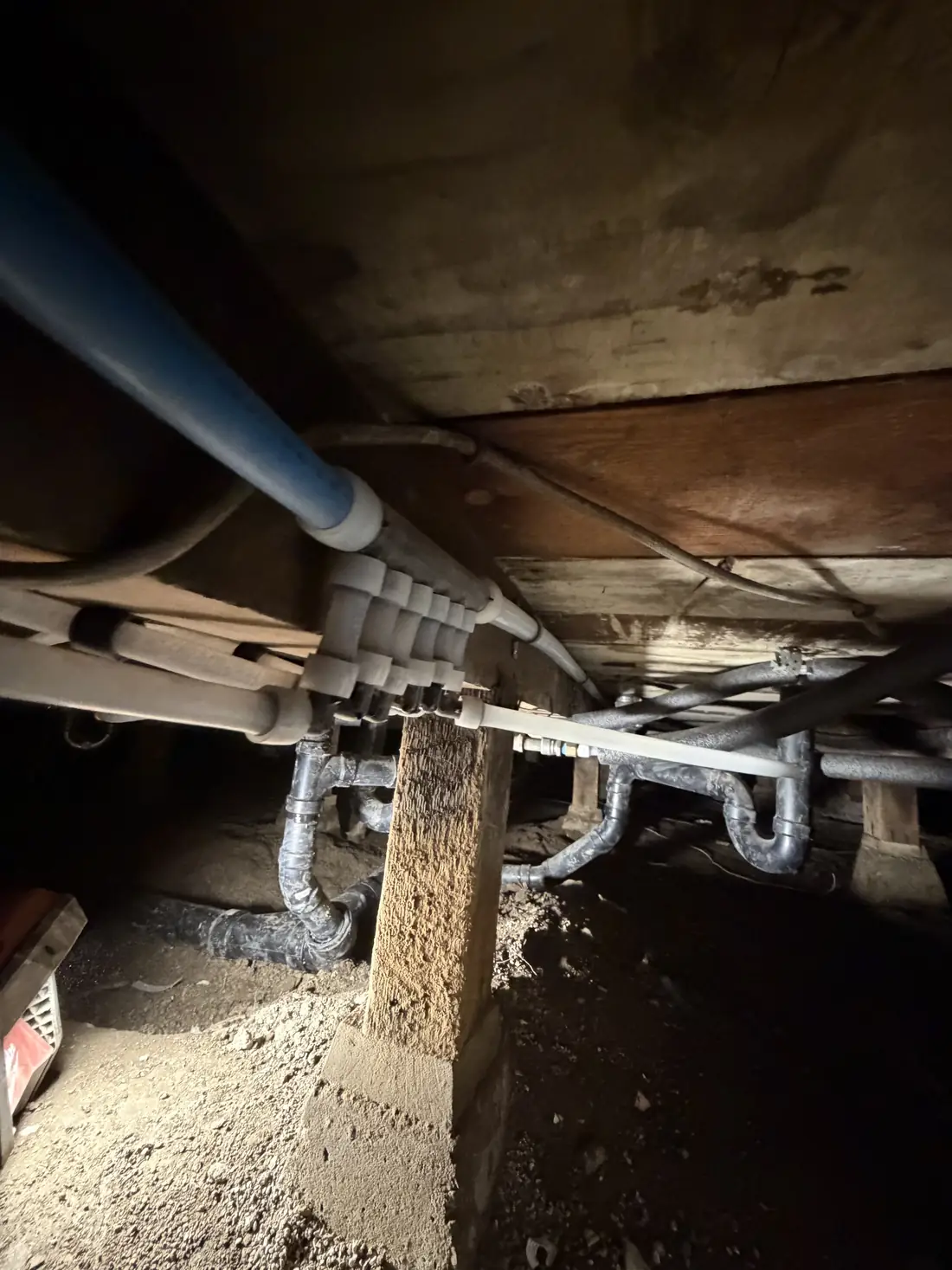 Drain and supply lines running under a house