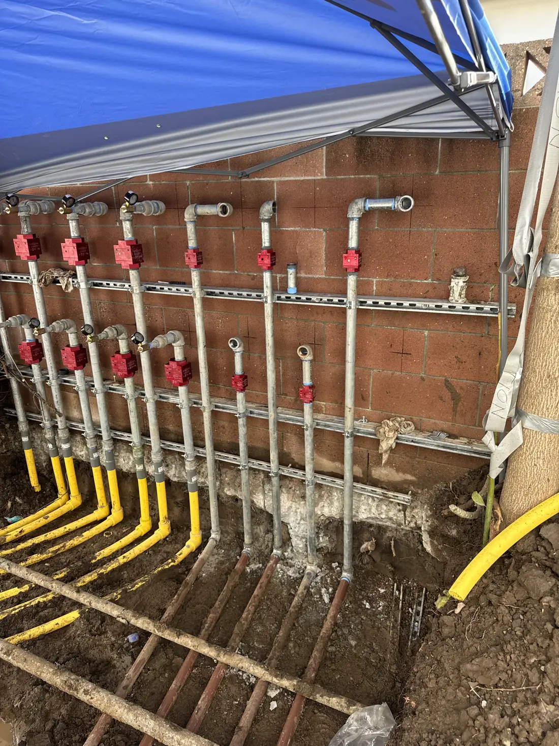 New gas line manifold with yellow gas piping and shutoff valves