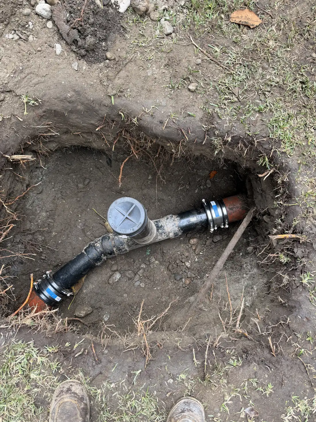 New sewer pipe and cleanout installed in an open trench