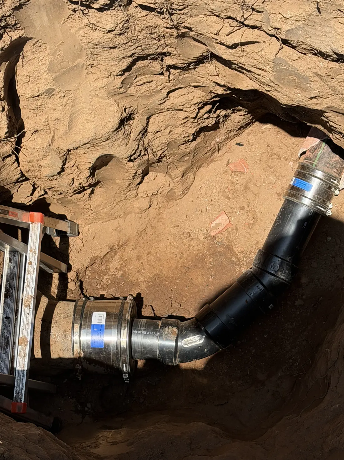 New sewer pipe joined to the existing line with a shielded coupling